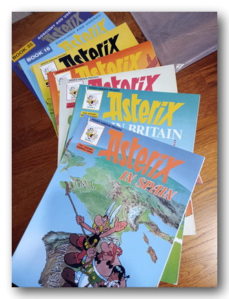 Collection of Asterix comic books on a wooden surface