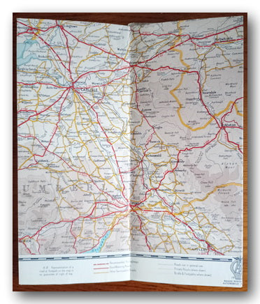 Folded map with roads and geographical features on a table.
