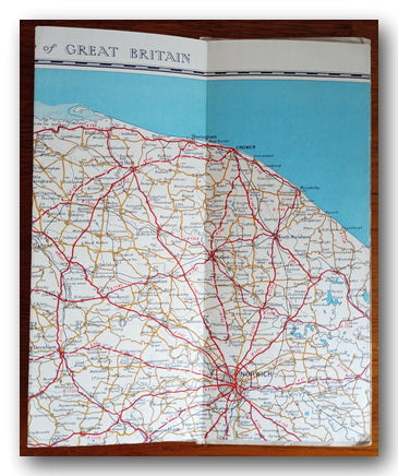 Map of Norwich area, Great Britain with roads and cities, on a table.