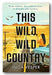 Book cover for 'This Wild, Wild Country' by Inga Vesper, featuring a desert landscape with a woman sitting in a car by the road, large black title text, and a light blue sky.