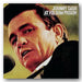 Album cover of 'Johnny Cash at Folsom Prison' with a close-up of Johnny Cash speaking into a microphone.
